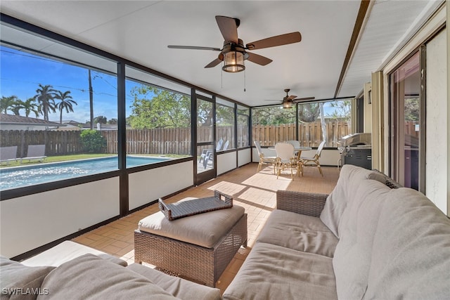 sunroom / solarium with plenty of natural light and ceiling fan