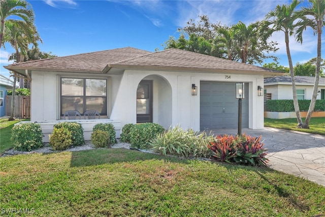 view of front facade with a front lawn and a garage