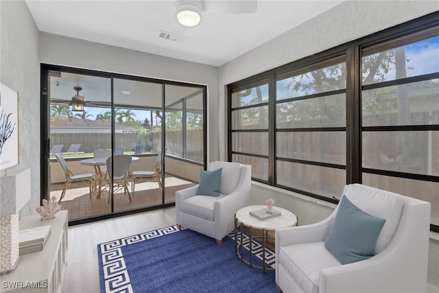 sunroom with ceiling fan