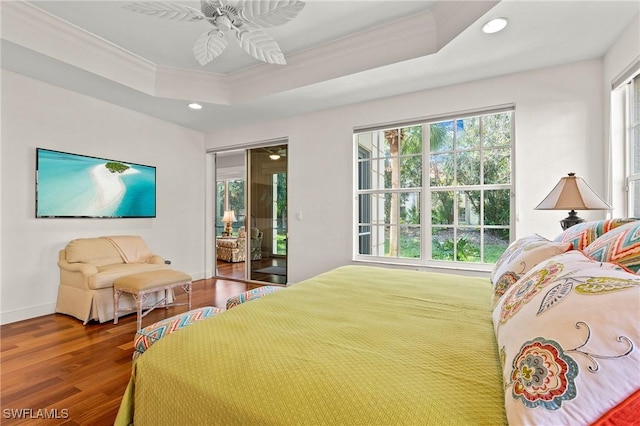 bedroom featuring access to exterior, ceiling fan, a raised ceiling, and dark hardwood / wood-style flooring