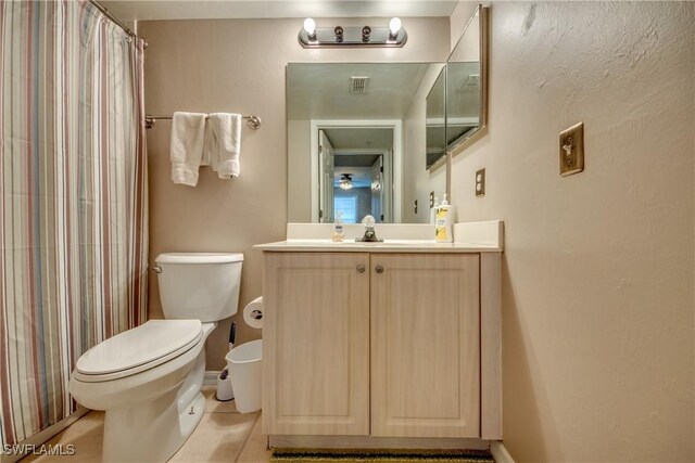 full bathroom featuring visible vents, a shower with shower curtain, toilet, tile patterned floors, and vanity