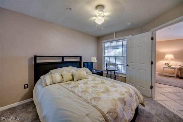 bedroom featuring tile patterned flooring, carpet flooring, and baseboards