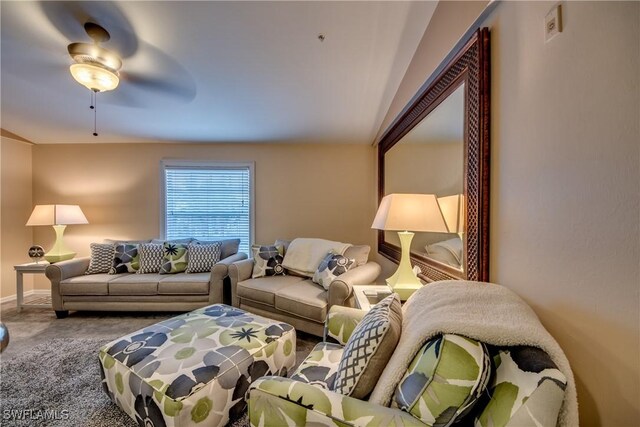 carpeted living room with ceiling fan