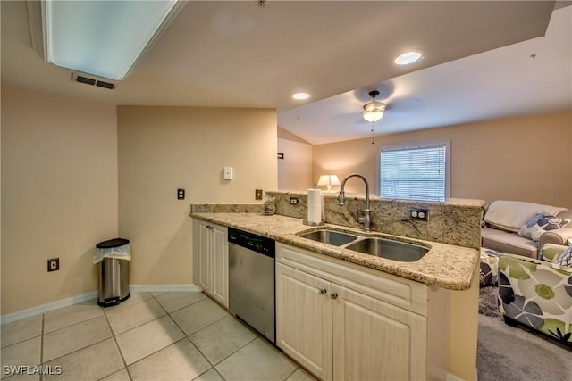 kitchen featuring light stone counters, open floor plan, a peninsula, stainless steel dishwasher, and a sink