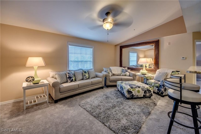 living area with lofted ceiling, baseboards, carpet floors, and a ceiling fan