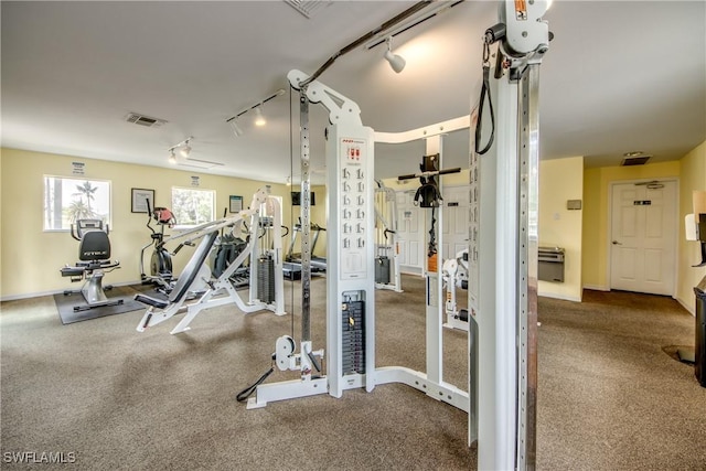 gym with rail lighting and visible vents