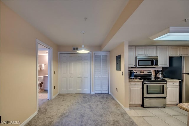 kitchen with light carpet, visible vents, baseboards, appliances with stainless steel finishes, and pendant lighting