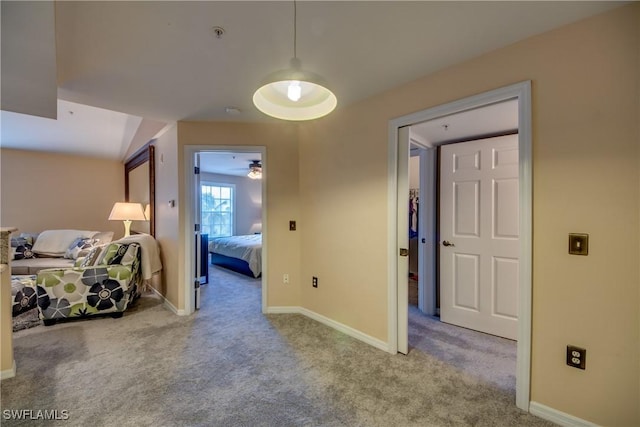 bedroom featuring light carpet and baseboards