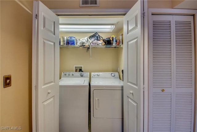 laundry area with washer and dryer, laundry area, and visible vents