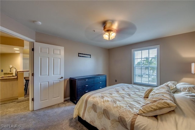 bedroom featuring a ceiling fan and light carpet