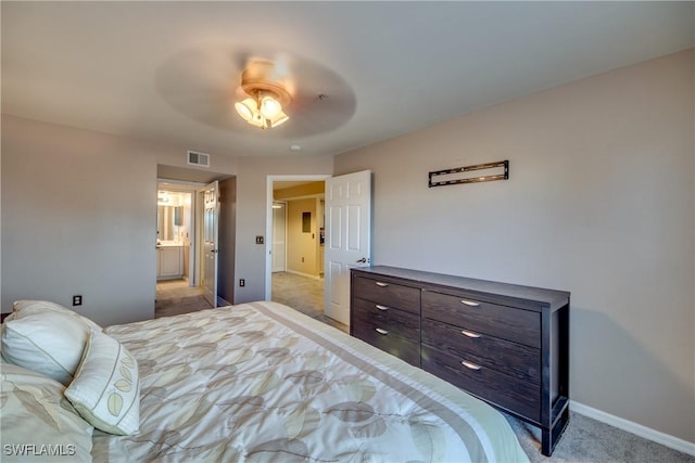 bedroom with baseboards, visible vents, connected bathroom, light colored carpet, and ceiling fan