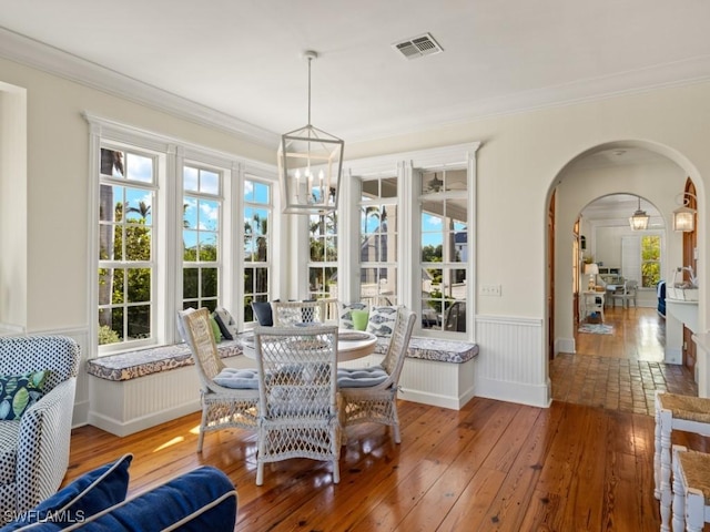 sunroom / solarium with a chandelier