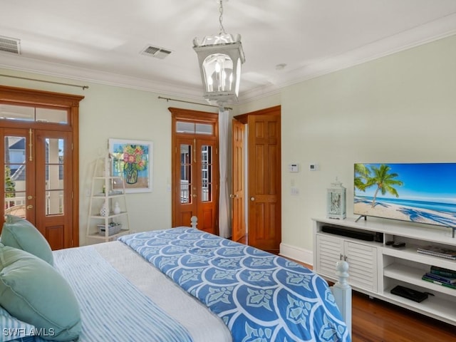 bedroom featuring french doors, dark hardwood / wood-style flooring, and ornamental molding