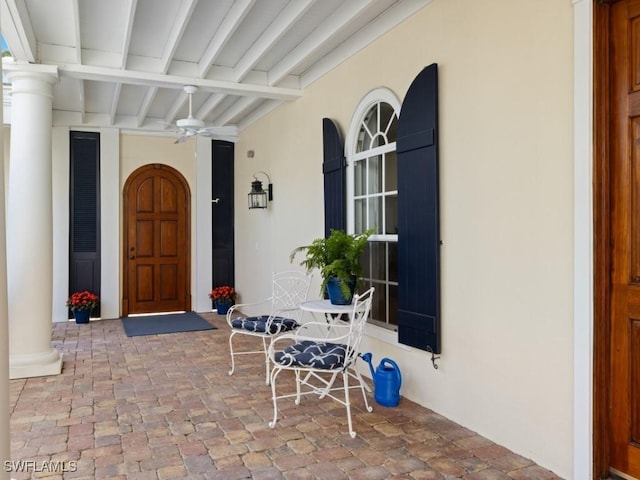 property entrance with ceiling fan and a porch