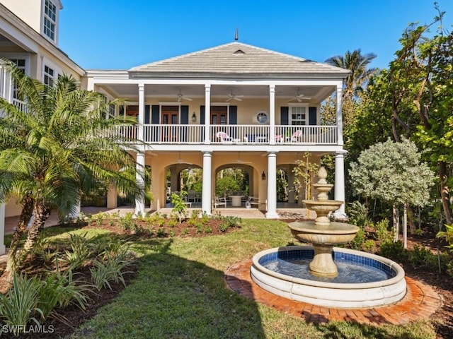 back of house with a yard, a balcony, ceiling fan, and a patio area