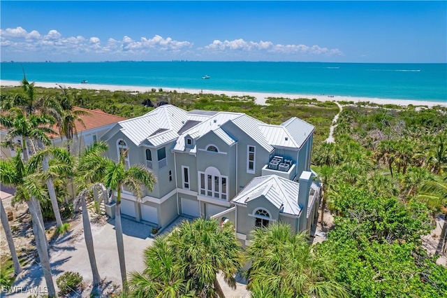 drone / aerial view with a water view and a beach view