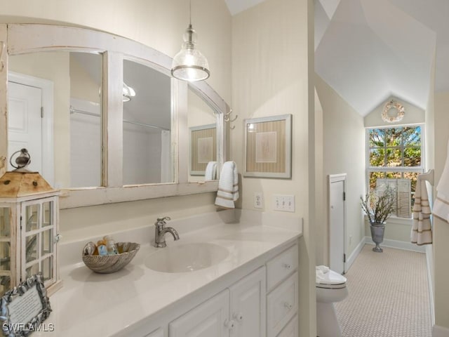 bathroom with vanity, toilet, and lofted ceiling