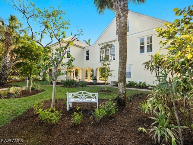 rear view of property featuring a yard