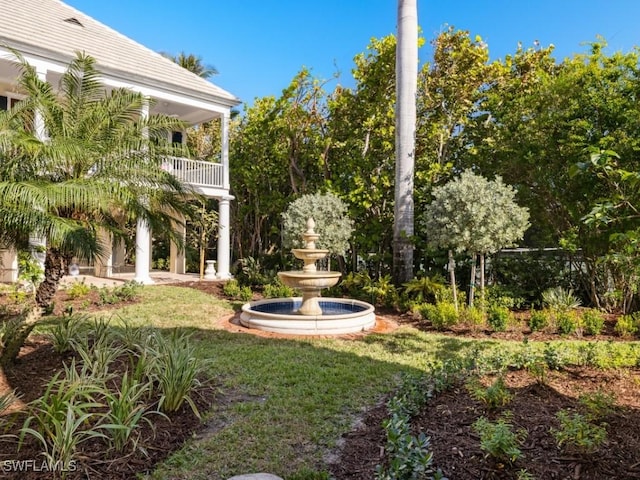 view of yard with a balcony