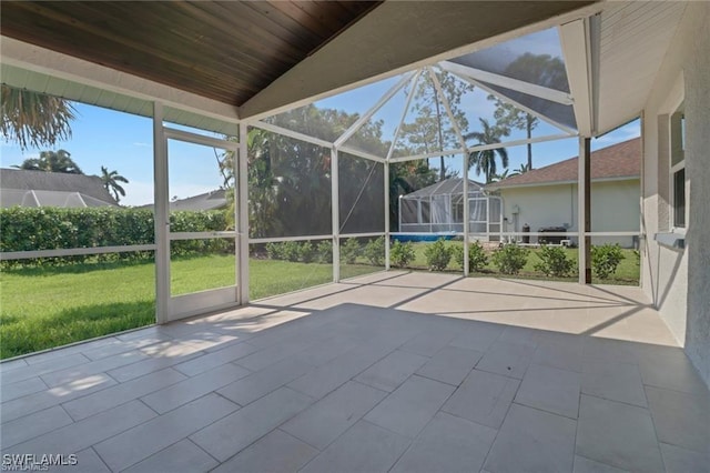 unfurnished sunroom with lofted ceiling and wooden ceiling