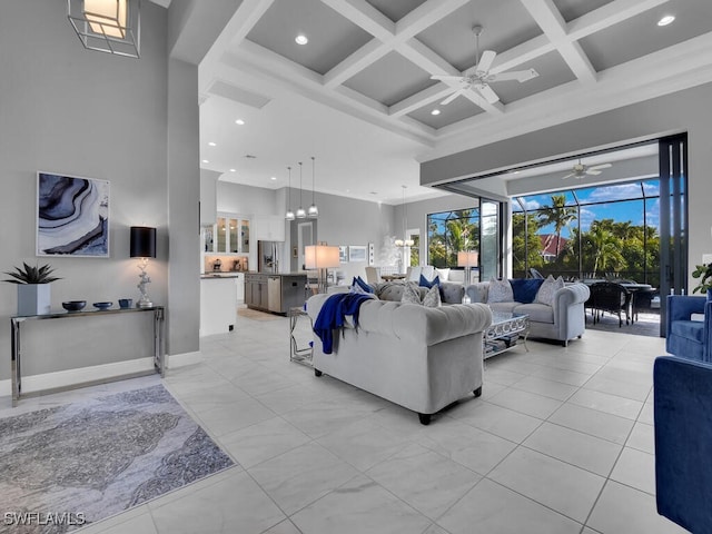 living room featuring beamed ceiling, ceiling fan, a towering ceiling, and coffered ceiling