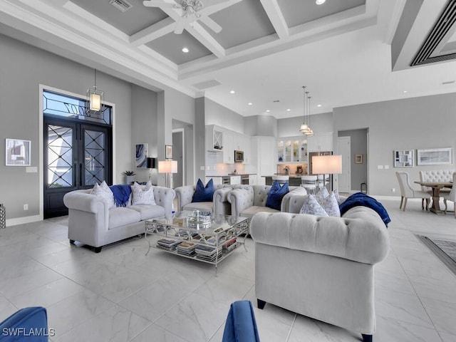 living room with french doors, coffered ceiling, ceiling fan, a towering ceiling, and beamed ceiling