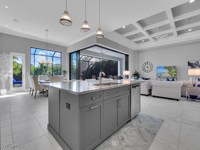 kitchen featuring stainless steel dishwasher, light stone counters, a kitchen island with sink, sink, and pendant lighting