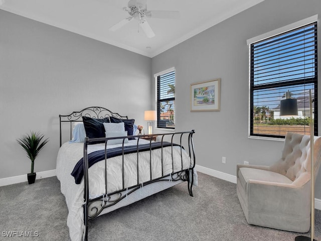 carpeted bedroom featuring ceiling fan and ornamental molding