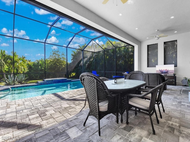 view of swimming pool featuring glass enclosure, ceiling fan, and a patio