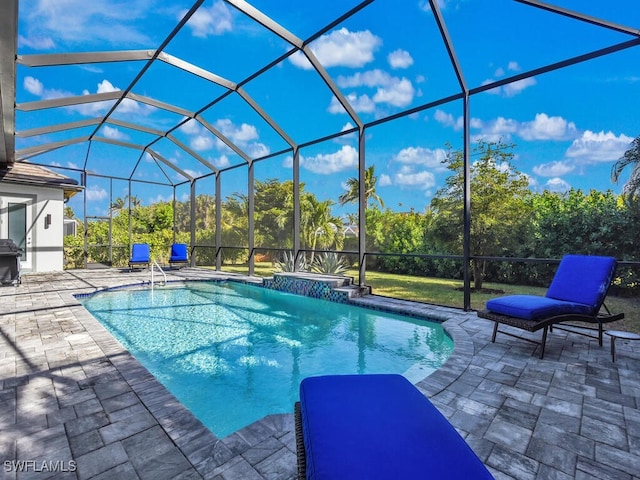 view of pool with a patio area and a lanai