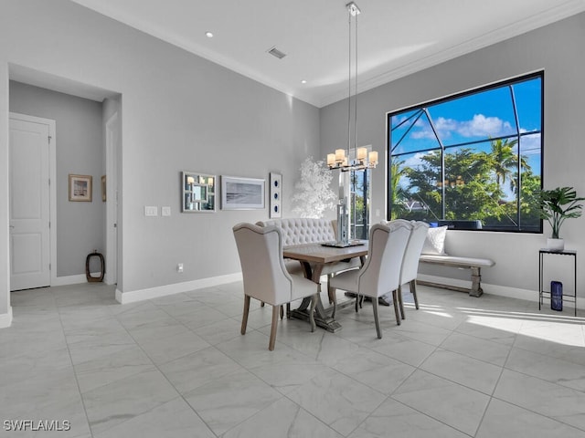 dining space with ornamental molding and a chandelier