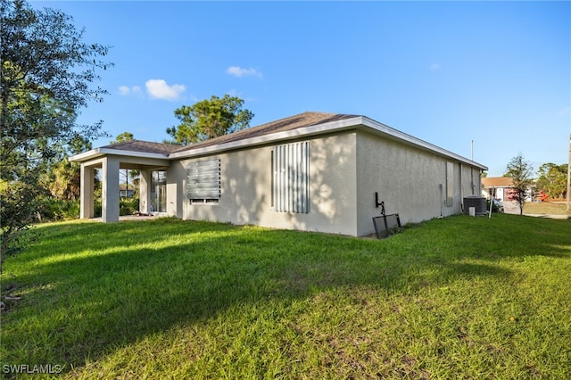 view of side of property featuring a yard and cooling unit