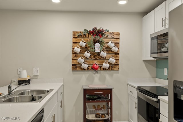 kitchen with sink, white cabinetry, and stainless steel appliances