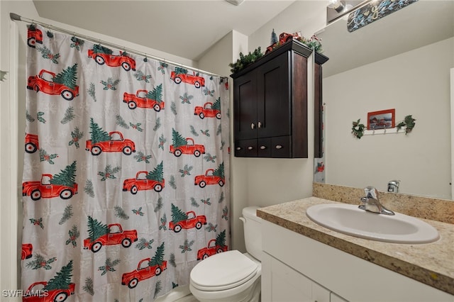 bathroom with vanity, toilet, and walk in shower