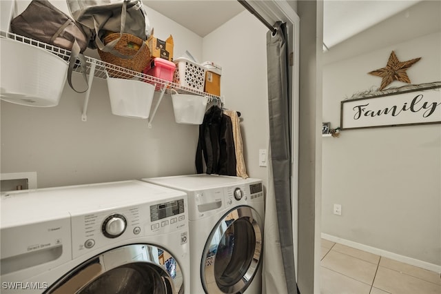 laundry room featuring washer and dryer and light tile patterned floors