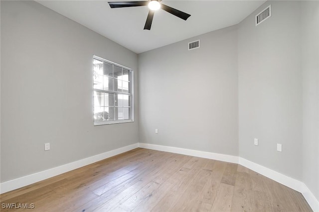 empty room with ceiling fan and light hardwood / wood-style flooring