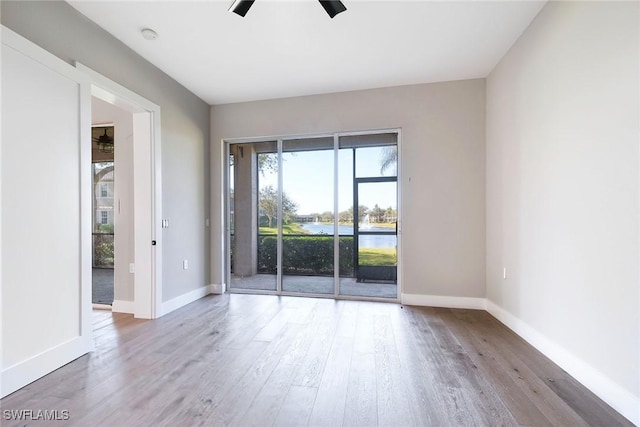 spare room with hardwood / wood-style flooring and ceiling fan