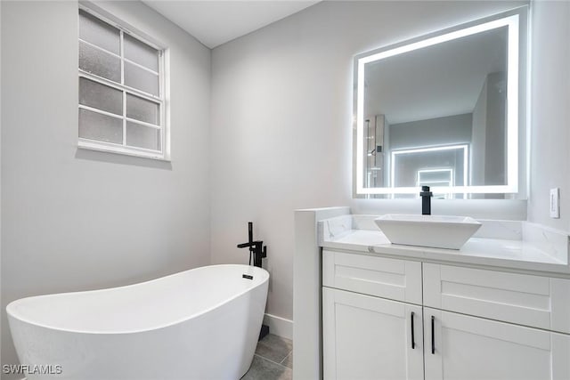 bathroom with tile patterned floors, vanity, and a bath