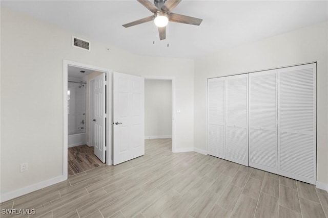 unfurnished bedroom featuring ceiling fan, a closet, and ensuite bathroom