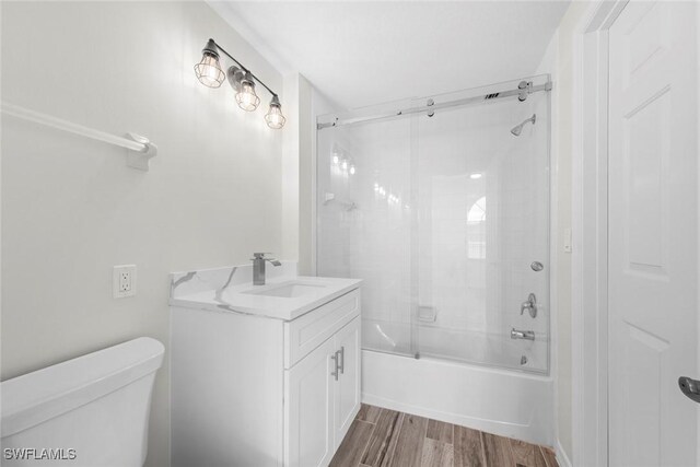 full bathroom with vanity, toilet, and shower / bath combination with glass door