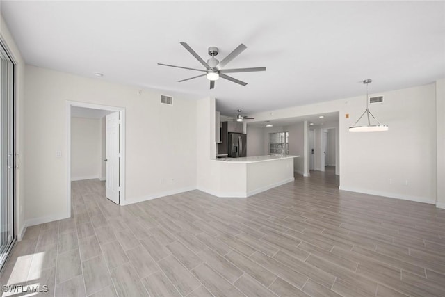 unfurnished living room with ceiling fan