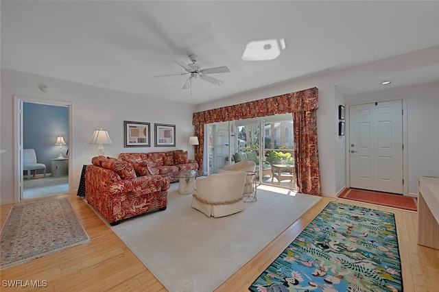 living room featuring wood finished floors and a ceiling fan