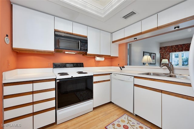 kitchen featuring white appliances, white cabinetry, ornamental molding, and sink