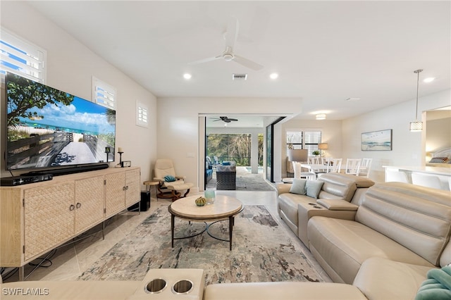 living room with ceiling fan and a healthy amount of sunlight