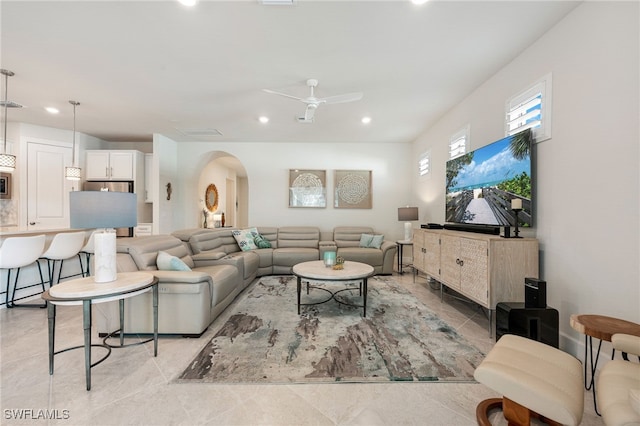 tiled living room with ceiling fan