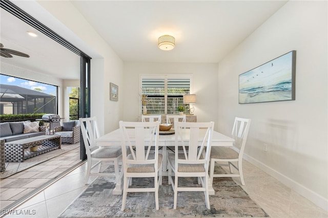 dining space with tile patterned floors and ceiling fan