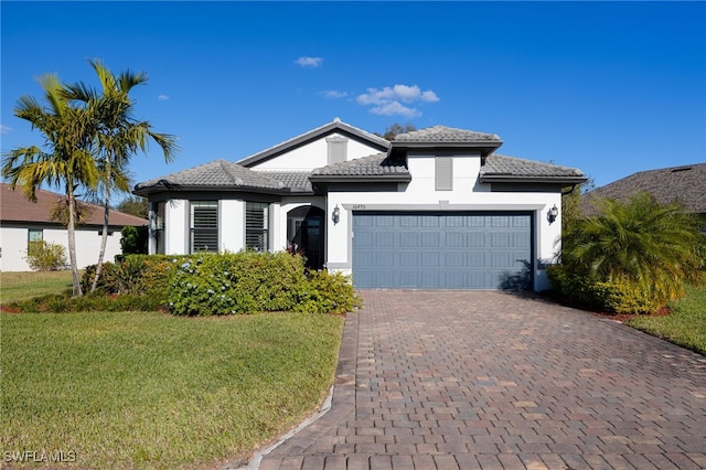 view of front of property featuring a garage and a front lawn