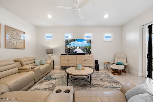 living room featuring a wealth of natural light, ceiling fan, and light tile patterned flooring