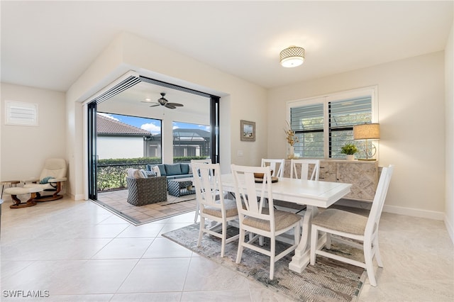 tiled dining room featuring a wealth of natural light and ceiling fan