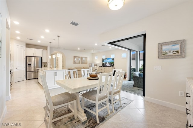 dining area featuring light tile patterned floors and sink